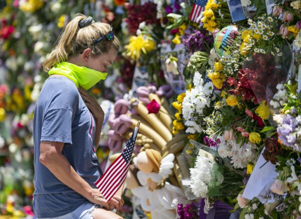 Miami Beach resident Tracey Lynne visits a makeshift memorial