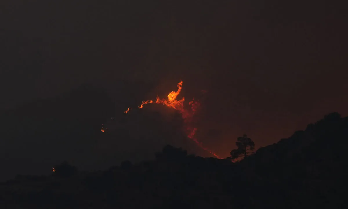 A view of flames from a fire in the Larnaca mountain region in Cyprus on July 3, 2021. (Petros Karadjias/AP Photo)