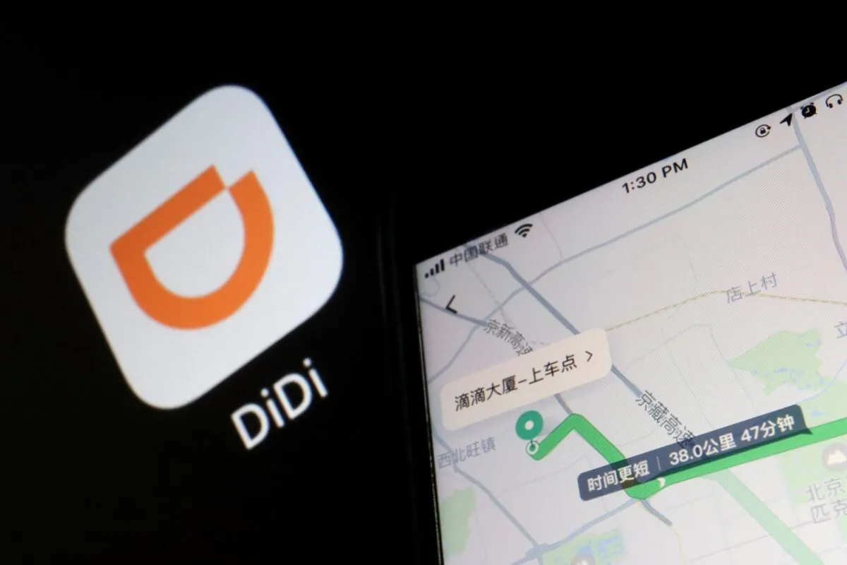 A navigation map on the app of Chinese ride-hailing giant Didi is seen on a mobile phone in front of the app logo displayed in this illustration picture taken July 1, 2021. (Reuters/Florence Lo/Illustration)
