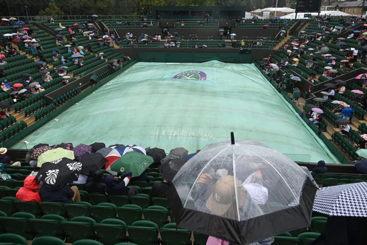 General view of court covered as rain delays play at The Wimbledon Championships at the All England Lawn Tennis and Croquet Club, in London, Britain, on July 3, 2021. (Toby Melville/Reuters)