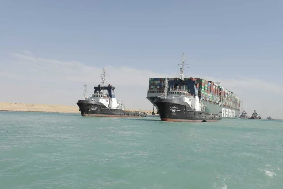 Released by Suez Canal Authority, the Ever Given, a Panama-flagged cargo ship is accompanied by Suez Canal tugboats as it moves in the Suez Canal, Egypt, on March 29, 2021. (Suez Canal Authority via AP)