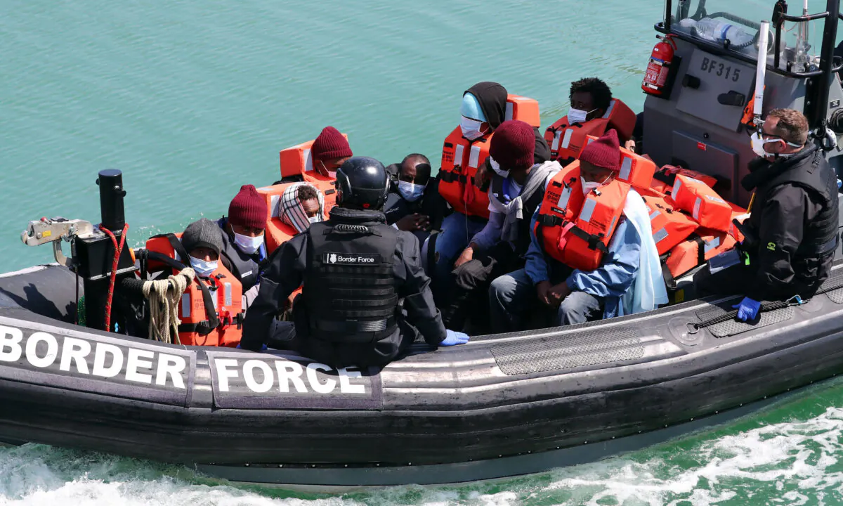 A group of people thought to be illegal migrants are brought in to Dover, Kent, following a small boat incident in the Channel on June 6, 2021. (Gareth Fuller/PA)