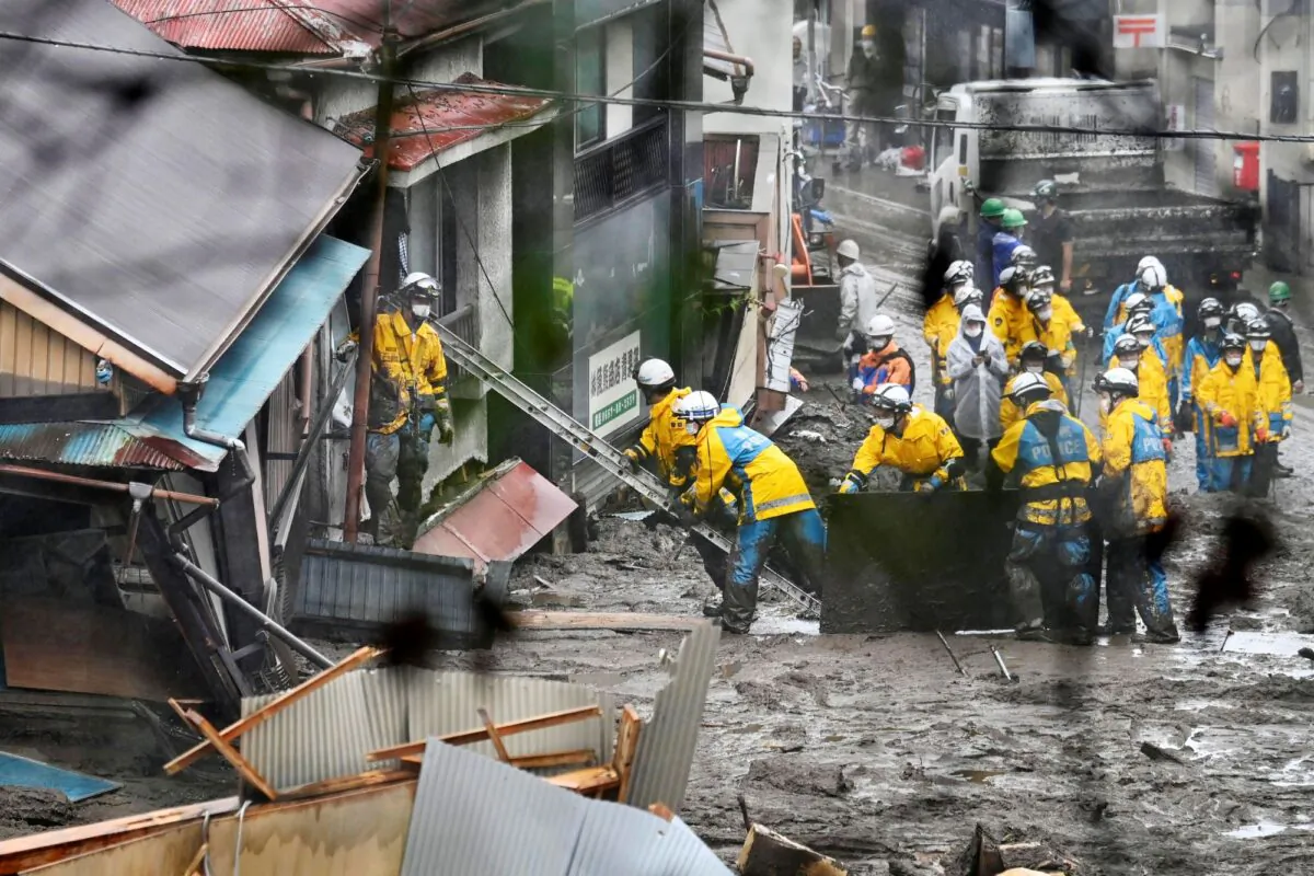 Rescuers conduct a search operation inside a building at the site of a mudslide at Izusan in Atami, Shizuoka prefecture, southwest of Tokyo, Japan, on July 4, 2021. (Kyodo News via AP)