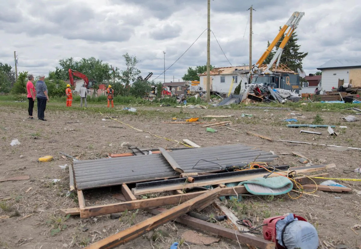 People survey the damage to homes following a Tornado in Mascouche, Que., on June 22, 2021. (The Canadian Press/Graham Hughes)