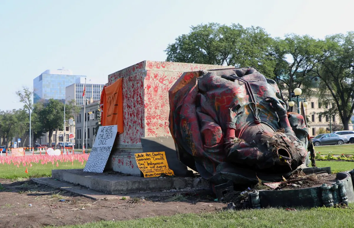 A vandalized statue of Queen Victoria lies on the ground at the provincial legislature in Winnipeg on July 2, 2021. The statue and one of Queen Elizabeth II were toppled on Canada Day during demonstrations concerning indigenous children who died at residential schools. (The Canadian Press/Kelly Geraldine Malone)