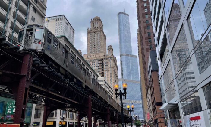 Chicago downtown as a train rides on the Loop, the elevated rail that forms the Chicago "L" system, on June 30, 2021. (Daniel Slim/AFP via Getty Images)