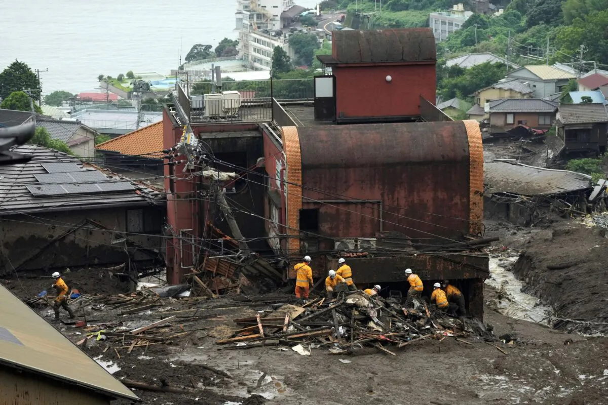 Rescuers search through a mudslide area caused by heavy rains at Izusan district in Atami, Shizuoka Prefecture, Japan, on July 5, 2021. (Eugene Hoshiko/AP Photo)