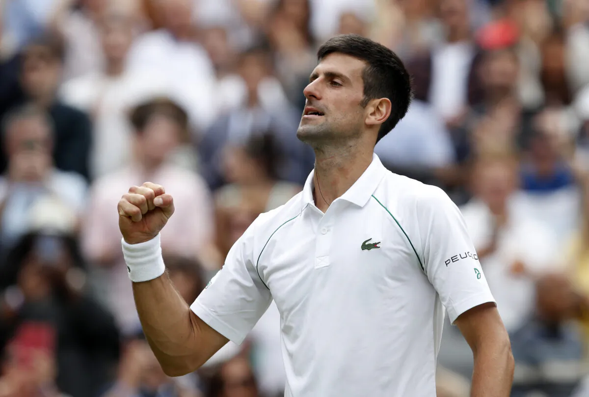 Serbia's Novak Djokovic celebrates after winning his fourth round match against Chile's Cristian Garin at the Wimbledon Tennis Championships at the All England Lawn Tennis and Croquet Club in London, UK, on July 5, 2021. (Paul Childs/ Reuters)