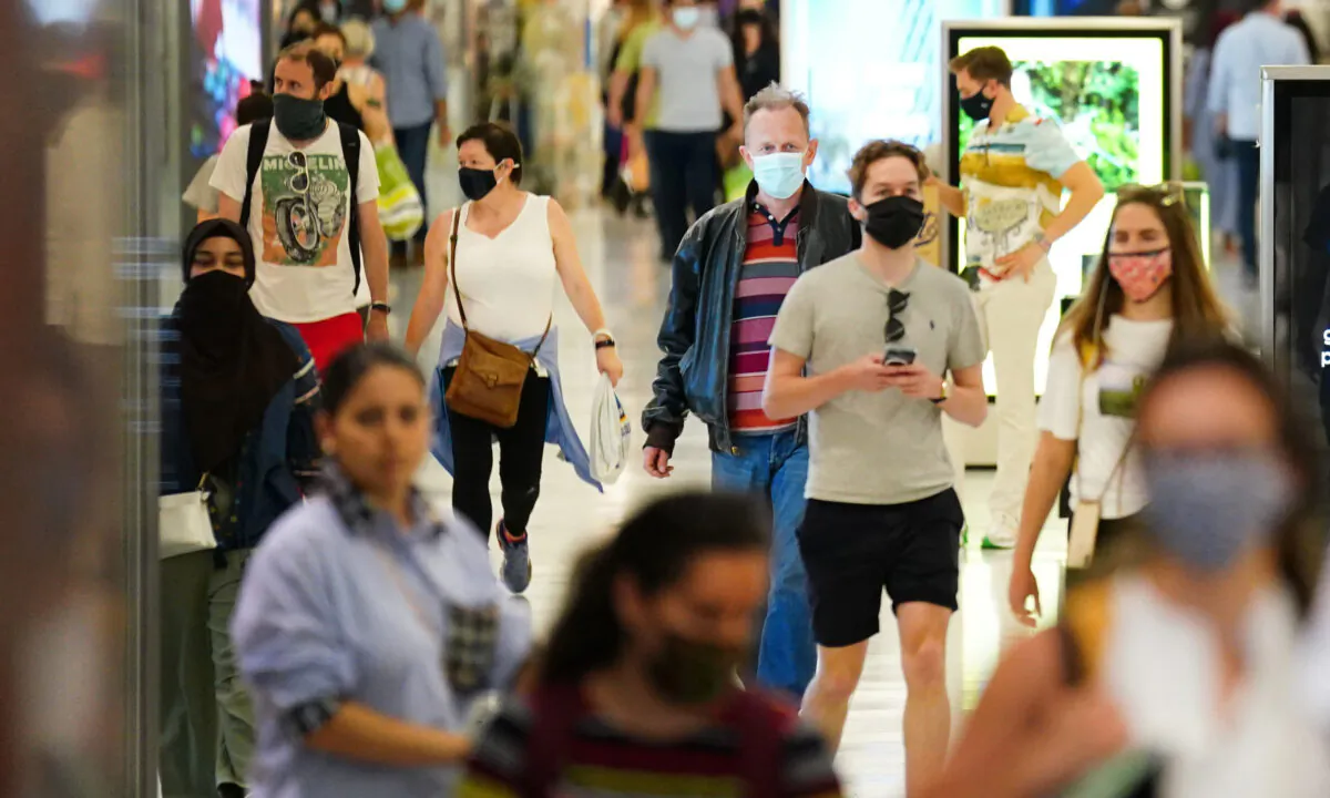 Shoppers wearing facemasks inside a shopping centre in East London on July 4, 2021. (Victoria Jones/PA)