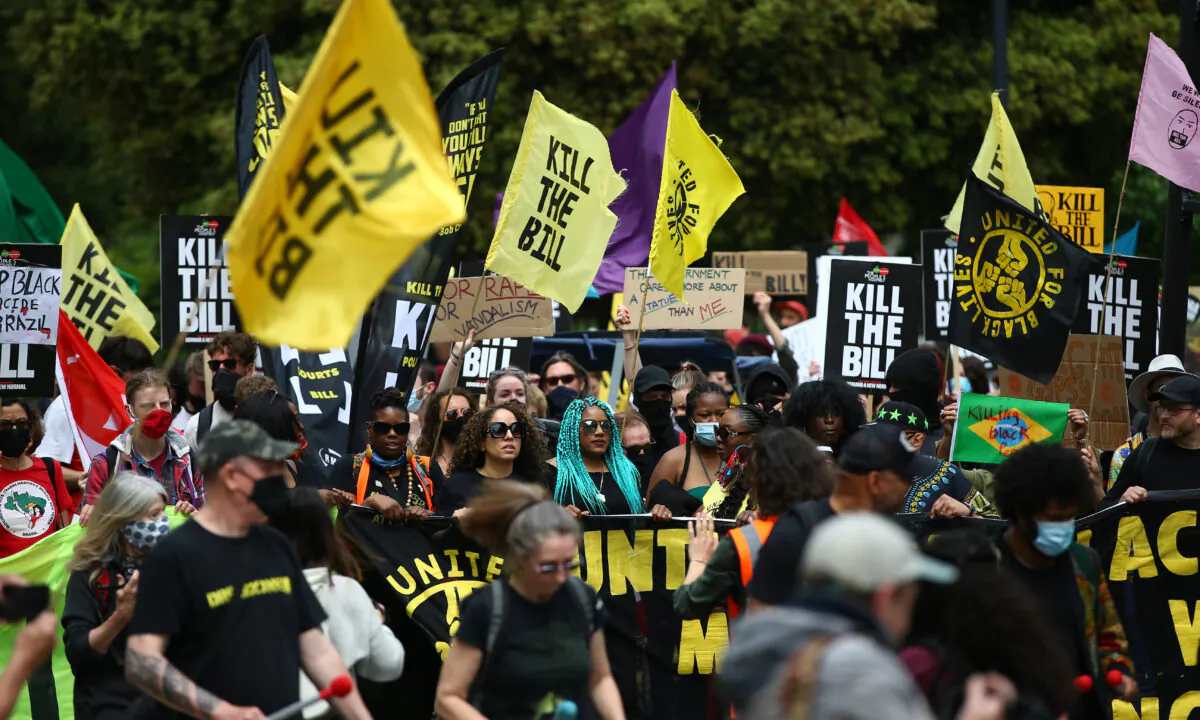 Protestors hold a banner during a "Kill the Bill" protest outside the British Museum in London on May 29, 2021. (Hollie Adams/Getty Images)