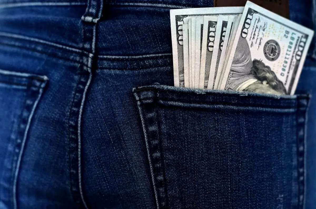 U.S. currency is seen in a back pocket in a file photo. (Timothy A. Clary/AFP via Getty Images)