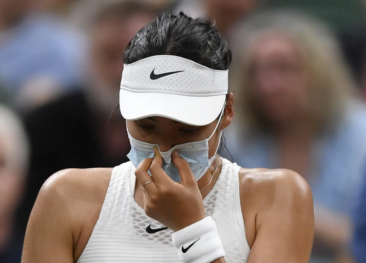 Britain's Emma Raducanu receives medical attention during her fourth round match against Australia's Ajla Tomljanovic during Tennis - Wimbledon at All England Lawn Tennis and Croquet Club in London, Britain, on July 5, 2021. (Toby Melville/Reuters)