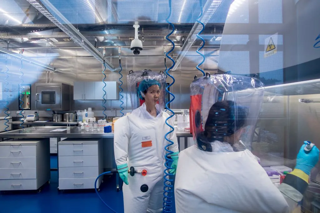Chinese virologist Shi Zhengli (L) is seen inside the P4 laboratory in Wuhan, capital of China's Hubei province on Feb. 23, 2017. The P4 epidemiological laboratory was built in co-operation with French bio-industrial firm Institut Merieux and the Chinese Academy of Sciences. (Johannes Eisele/AFP via Getty Images)