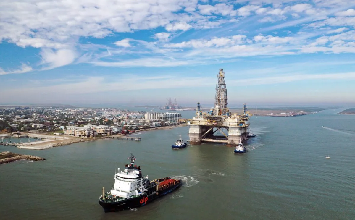 Tug boats tow the semi-submersible drilling platform Noble Danny Adkins through the Port Aransas Channel into the Gulf of Mexico in Port Aransas, Texas, on Dec. 12, 2020. (Tom Pennington/Getty Images)