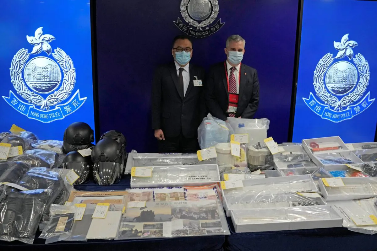 Senior Superintendent Li Kwai-wah (L) of Hong Kong Police National Security Department, and senior bomb disposal officer Alick McWhirter (R) of Explosive Ordnance Disposal Bureau, pose  during a news conference regarding nine people arrested over an alleged plot to plant bombs around Hong Kong, at the police headquarters in Hong Kong, on July 6, 2021. (Kin Cheung/AP Photo)