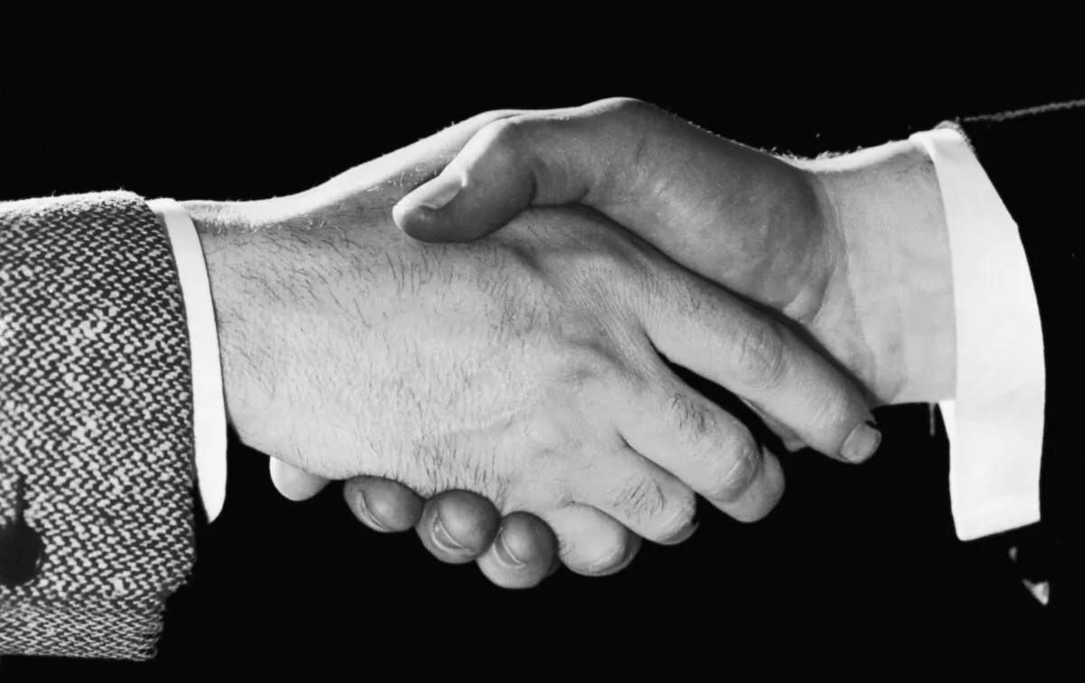 A close-up of two men shaking hands, in a file photo. (FPG/Hulton Archive/Getty Images)