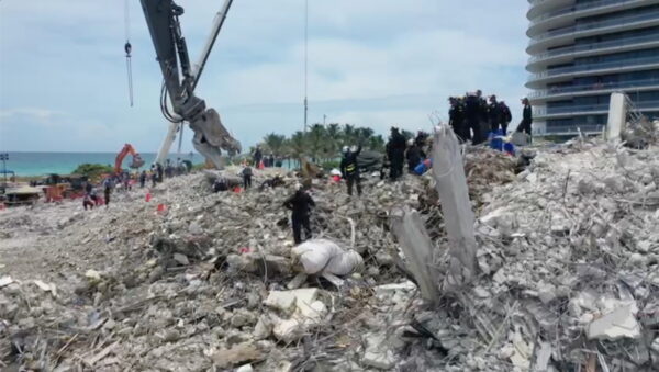Search-and-rescue crew personnel on the debris of the collapsed Champlain Towers