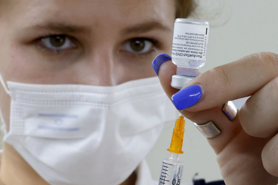 An Israeli medical worker prepares a dose of the Pfizer/BioNTech COVID-19 vaccine from the Magen David Adom in Tel Aviv, on July 5, 2021. (Jack Guez/AFP via Getty Images)