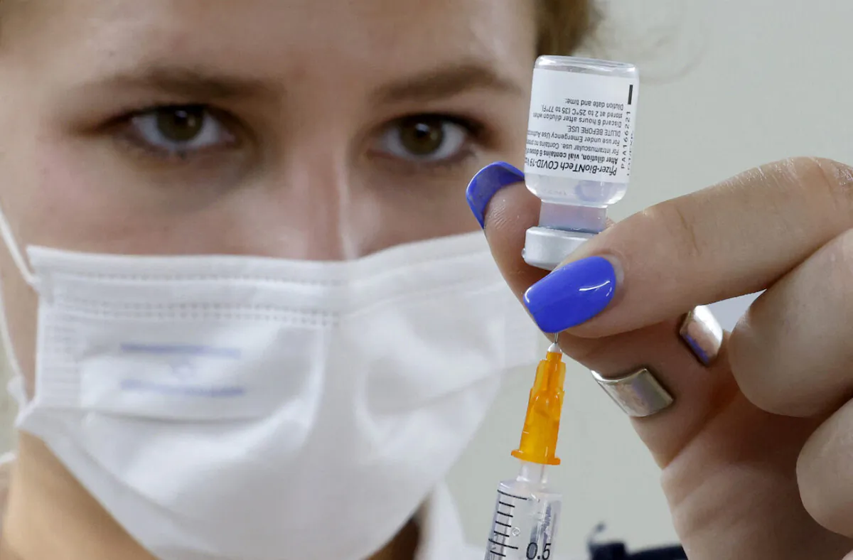 An Israeli medical worker prepares a dose of the Pfizer/BioNTech COVID-19 vaccine from the Magen David Adom in Tel Aviv, on July 5, 2021. (Jack Guez/AFP via Getty Images)