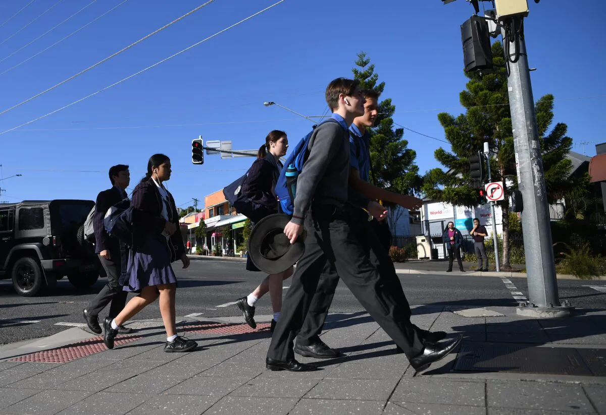 School students arrive for the first day of face-to-face schooling in Brisbane, Australia, May 11, 2020. (AAP Image/Dan Peled)