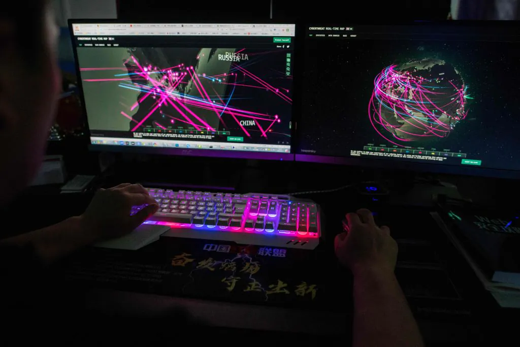 A member of the hacking group Red Hacker Alliance uses a website that monitors global cyberattacks on his computer at an office in Dongguan, China's southern Guangdong Province, on Aug. 4, 2020. (Nicolas Asfouri/AFP via Getty Images)
