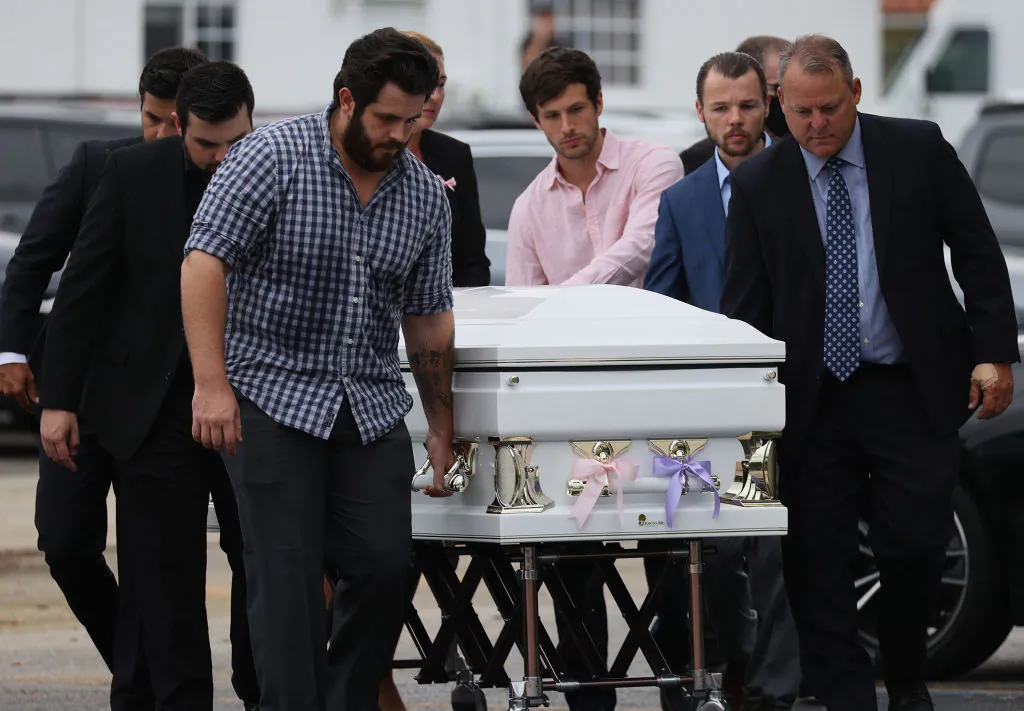 Pallbearers carry one of three caskets into the St. Joseph Catholic Church for the funeral of Anaely Rodriguez, her husband Marcus Guara, and their daughters  Lucia Guara, and Emma Guara at St. Joseph Catholic Church in Miami Beach, Fla., on July 6, 2021. (Joe Raedle/Getty Images)