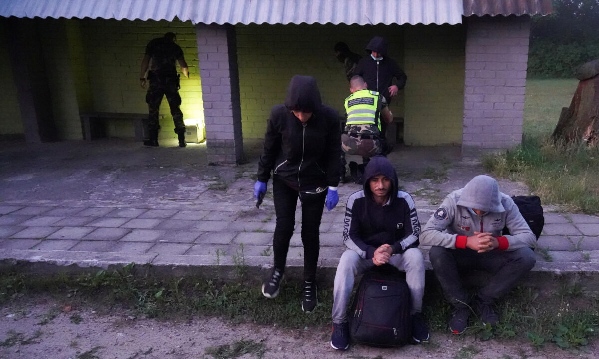 Lithuanian border guards detain migrants illegally crossing the border from Belarus to Lithuania, in Kalviai