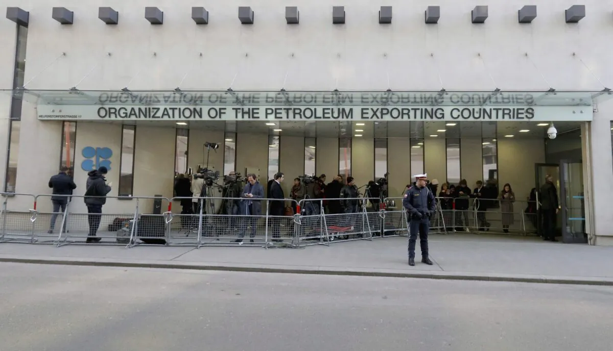 People stand in front of the Organization of the Petroleum Exporting Countries (OPEC) headquarters in Vienna, Austria, in a file photo. OPEC+ cancelled its July 5, 2021, meeting, leaving the oil market unsure of how supply will be regulated going forward. (AP Photo/Ronald Zak)