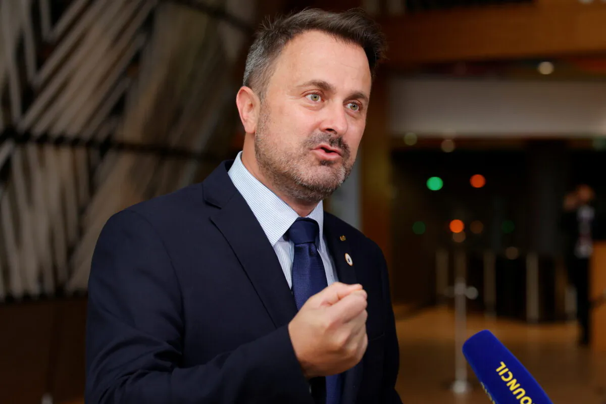 Luxembourg's Prime Minister Xavier Bettel talks to journalists as he arrives for the second day of a EU summit at the European Council building in Brussels, Belgium June 25, 2021. (Olivier Matthys/Pool via Reuters)