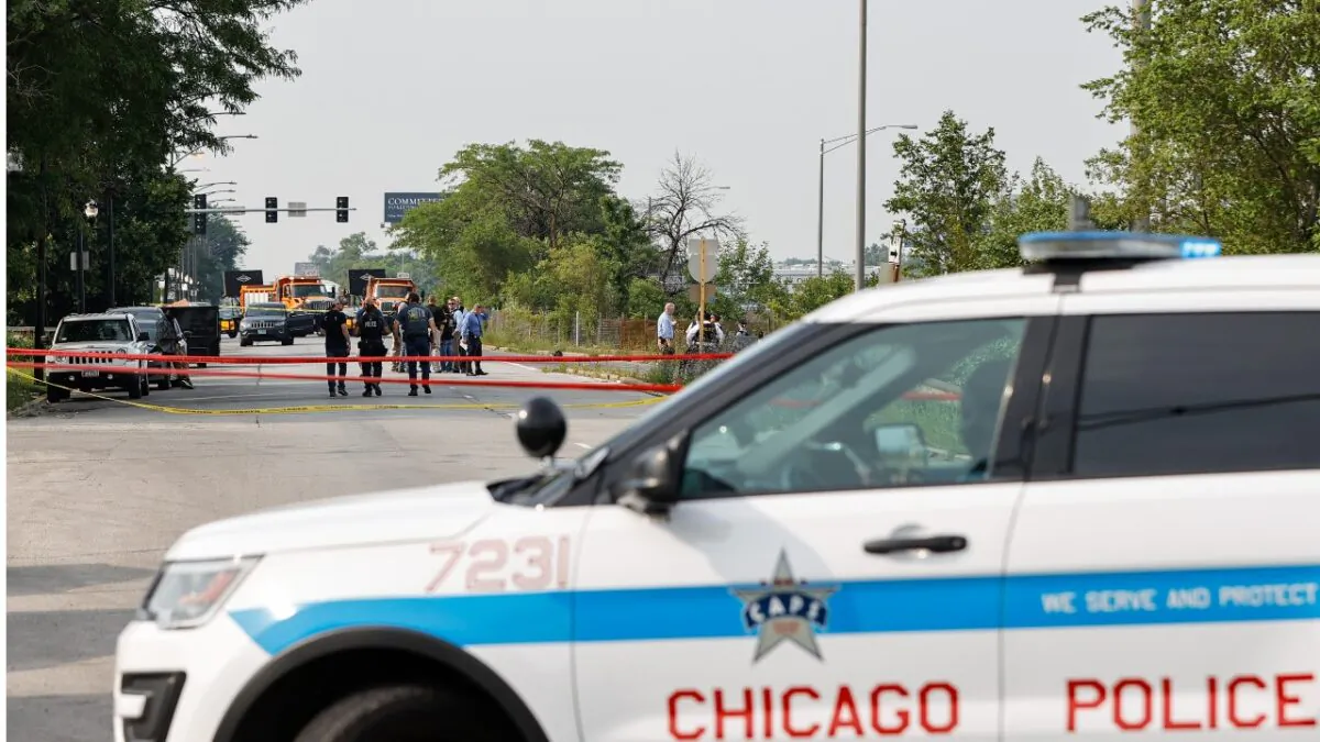 Law enforcement officers investigate the crime scene near the border between the Morgan Park and West Pullman neighborhoods in Chicago, Ill., on July 7, 2021. (Kamil Krzaczynski/Getty Images)
