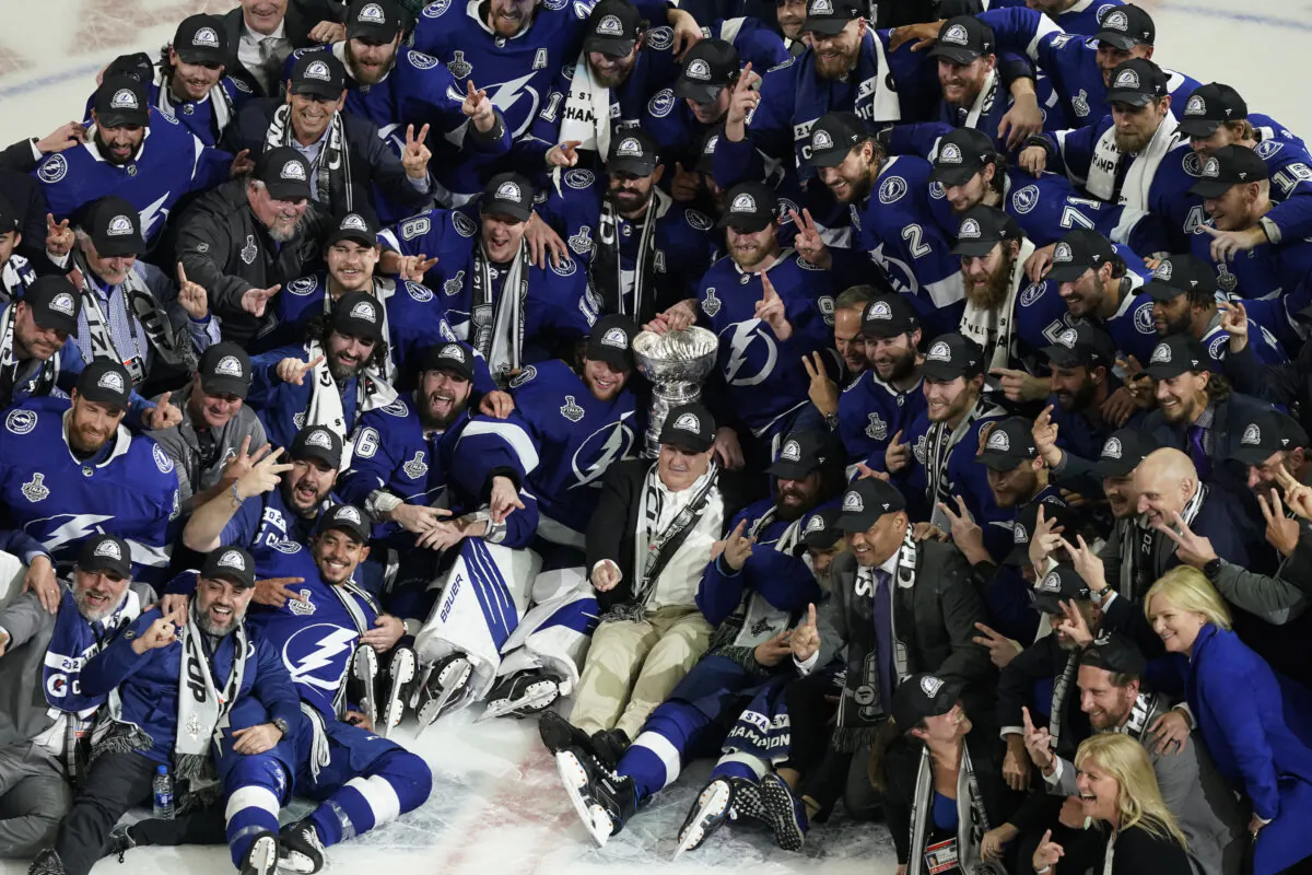 The Tampa Bay Lightning team poses with the Stanley Cup after Game 5 of the NHL hockey Stanley Cup finals against the Montreal Canadiens, in Tampa, Fla., on July 7, 2021. (Gerry Broome/AP Photo)
