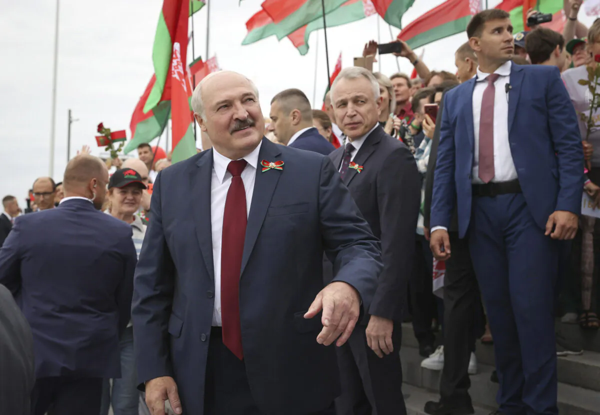 Belarusian President Alexander Lukashenko speaks with people after the wreath laying ceremony at Mound of Glory war memorial marking Independence Day, on the outskirts of the capital Minsk, Belarus, on July 3, 2021. (Maxim Guchek/BelTA Pool Photo via AP)