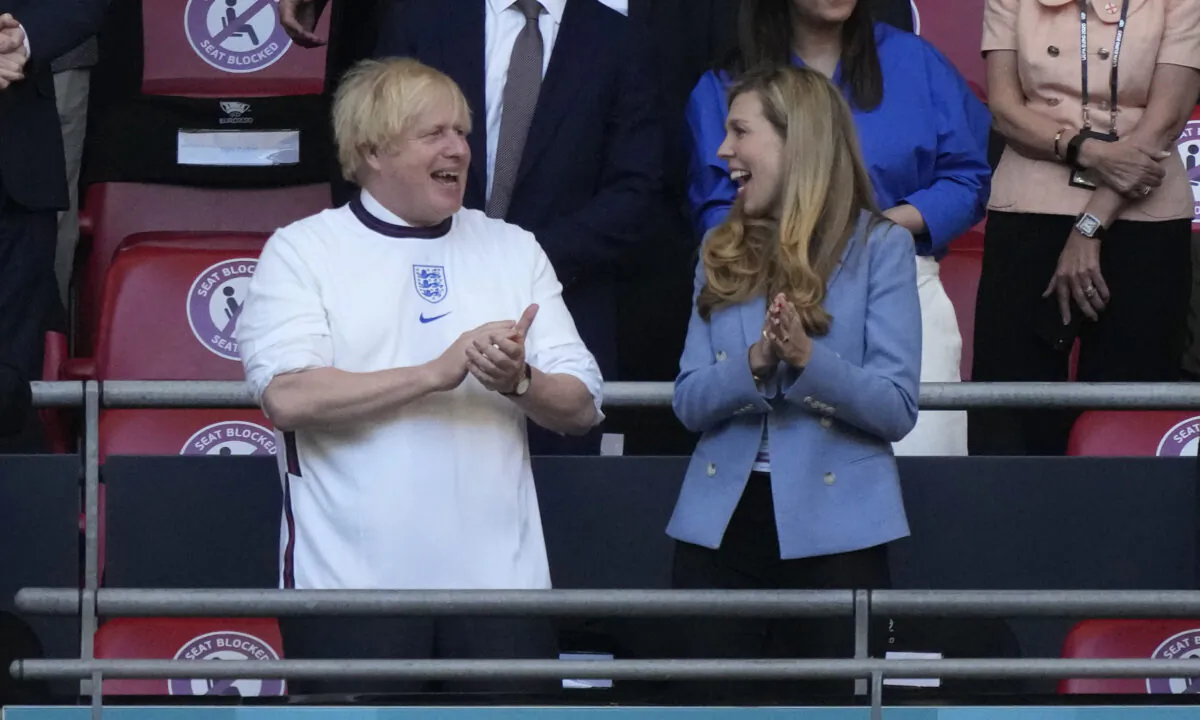 Boris Johnson, Prime Minister of United Kingdom and his wife, Carrie Johnson react prior to the UEFA Euro 2020 Championship Semifinal match between England and Denmark at Wembley Stadium in London on July 7, 2021. (Frank Augstein/Pool/Getty Images)
