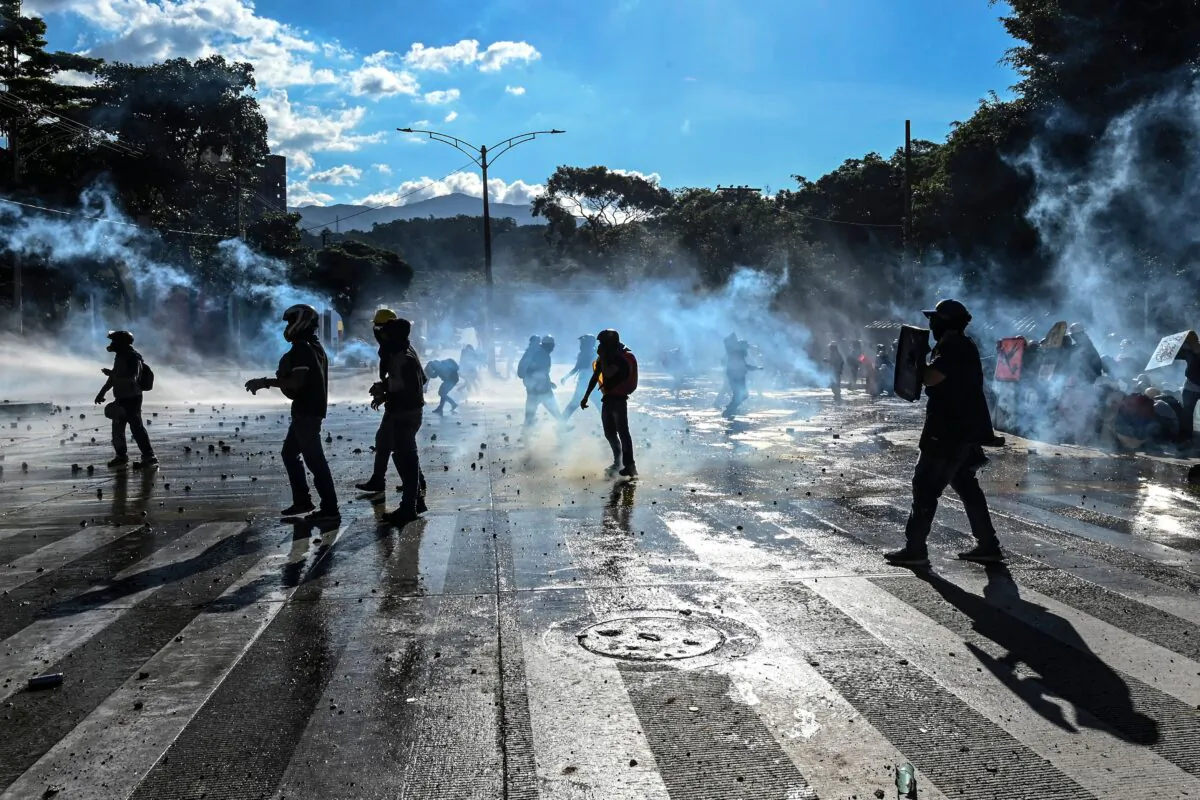 Demonstrators clash with riot police during a protest against the government in Medellin, Colombia, on June 28, 2021. (Joaquin Sarmiento/AFP via Getty Images