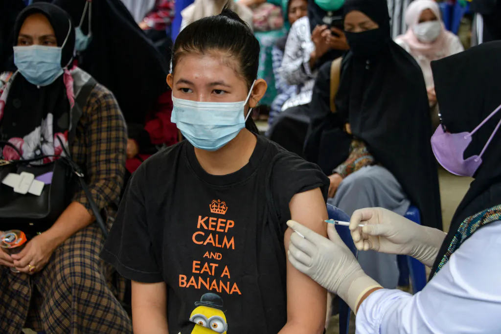 A woman receives a dose of Sinovac's Covid-19 coronavirus vaccine during a vaccination drive in Banda Aceh, Indonesia on July 7, 2021. (Chaideer Mahyuddin/AFP via Getty Images)