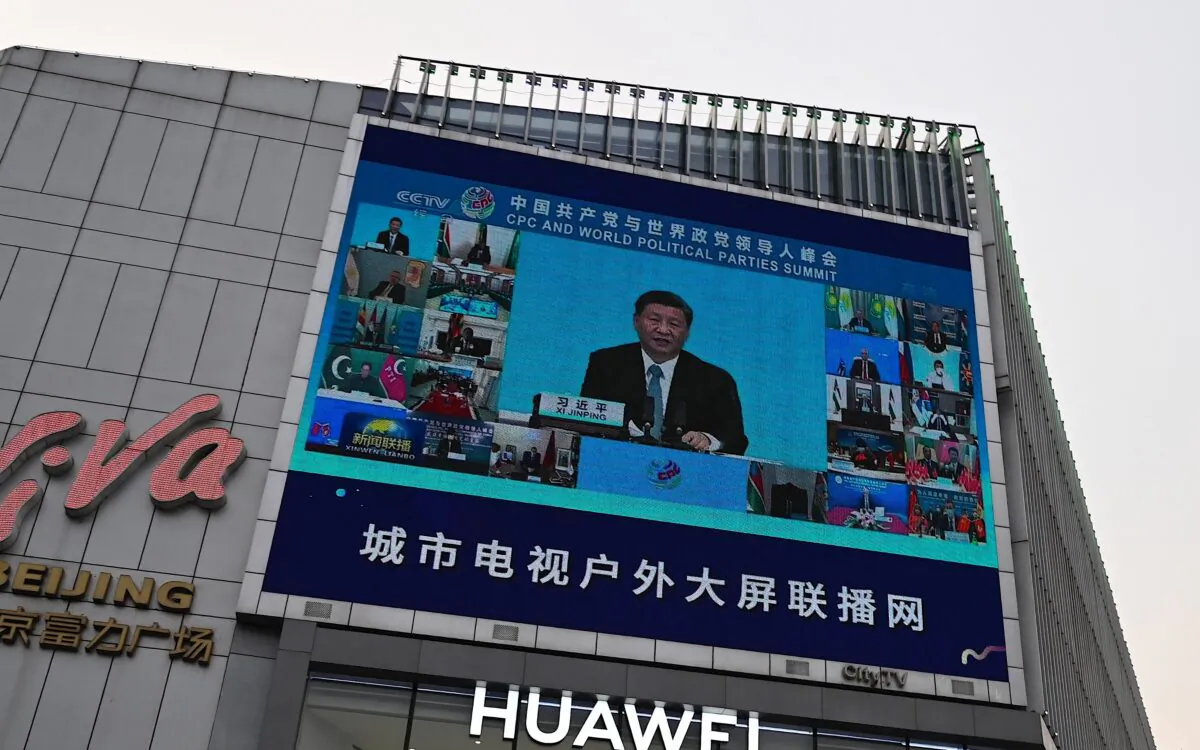 A screen outside a shopping mall shows news coverage of Chinese leader Xi Jinping delivering a speech during a Communist Party of China and World Political Parties summit, in Beijing on July 7, 2021. (Jade Gao/AFP via Getty Images)