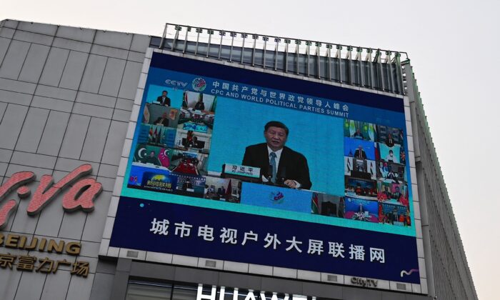 A screen outside a shopping mall shows news coverage of Chinese leader Xi Jinping delivering a speech during a Communist Party of China and World Political Parties summit, in Beijing on July 7, 2021. (Jade Gao/AFP via Getty Images)