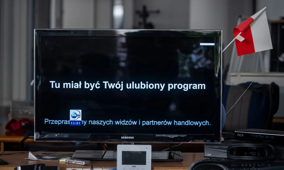 The screen of a TV is pictured broadcasting a black board and reading "This should be your favorite program" on the TVN channel as a sign of protest against a tax proposed by the new government, in Warsaw, on Feb. 10, 2021.  (Wojtek Radwanski/AFP via Getty Images)