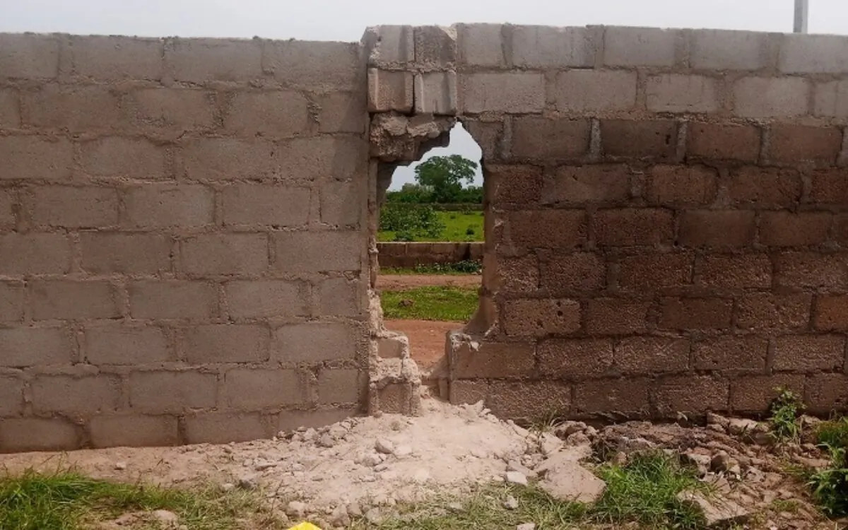 The hole knocked in the wall surrounding the Bethel Baptist High School in Kaduna state, Nigeria on July 5, 2021. Kidnappers used the hole to take the kidnapped students out of the compound. (Luka Binniyat/The Epoch Times)