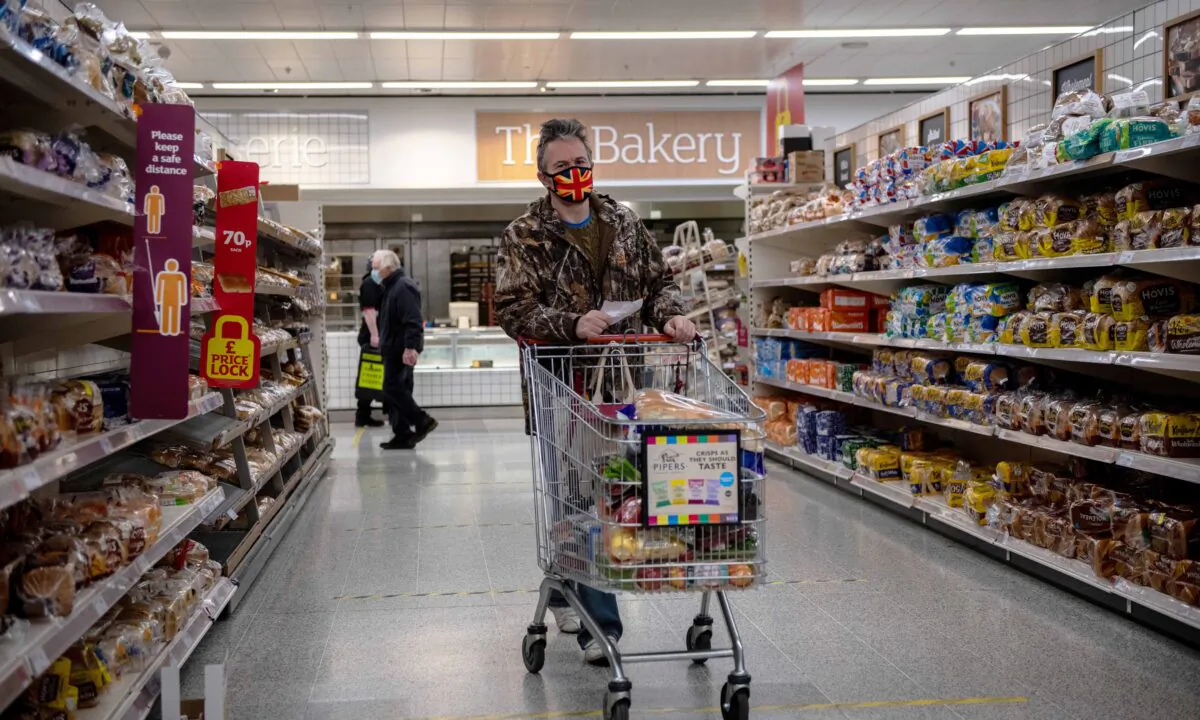 A man wearing a Union Jack flag design face mask shops in a Sainsburys supermarket in Tunbridge Wells, UK, on Jan. 12, 2021. (Chris J Ratcliffe/Getty Images)