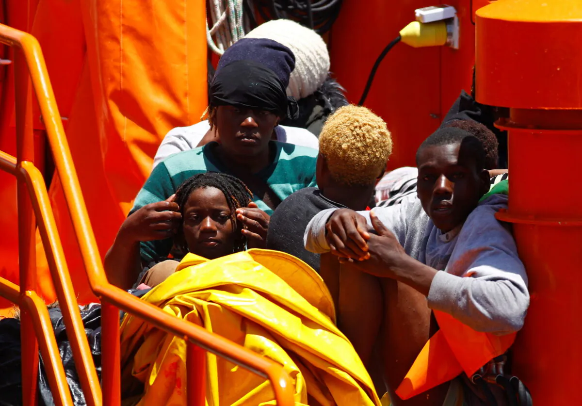 Migrants wait to disembark from a Spanish coast guard vessel, in the port of Arguineguin, on the island of Gran Canaria, Spain, on June 20, 2021. (Borja Suarez/Reuters)