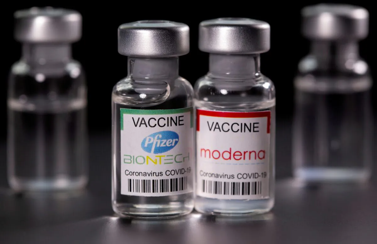 Vials with Pfizer-BioNTech and Moderna coronavirus disease (COVID-19) vaccine labels are seen in this illustration picture. (Dado Ruvic/Illustration/Reuters)