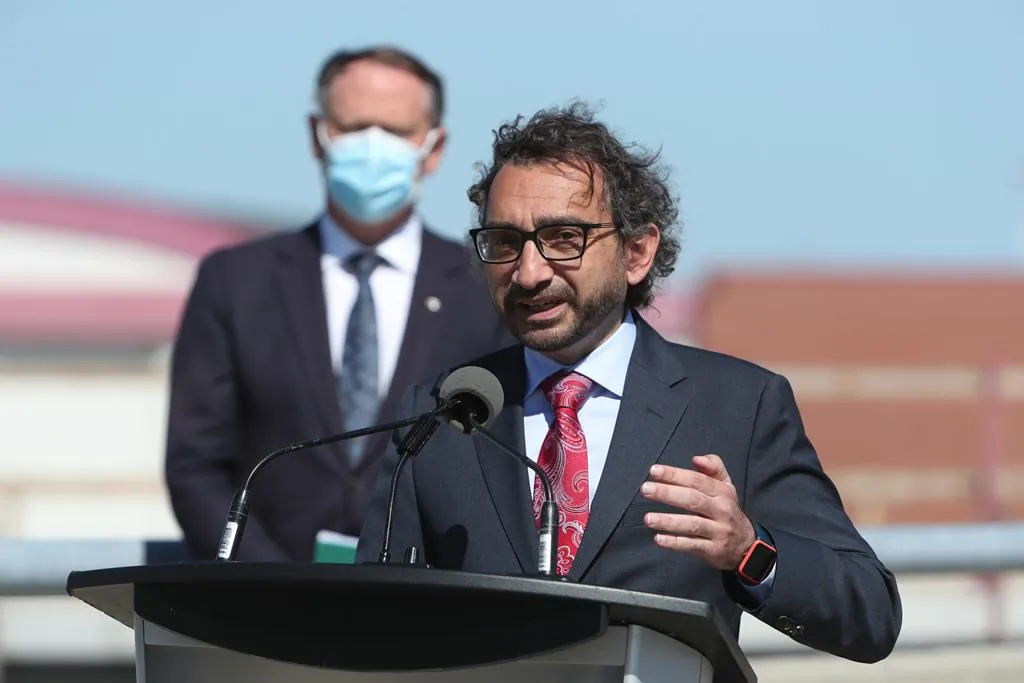 Transport Minister Omar Alghabra speaks while Ottawa South MP David McGuinty looks on during a press conference at the Ottawa MacDonald-Cartier International Airport on June 16, 2021. (The Canadian Press/David Kawai )