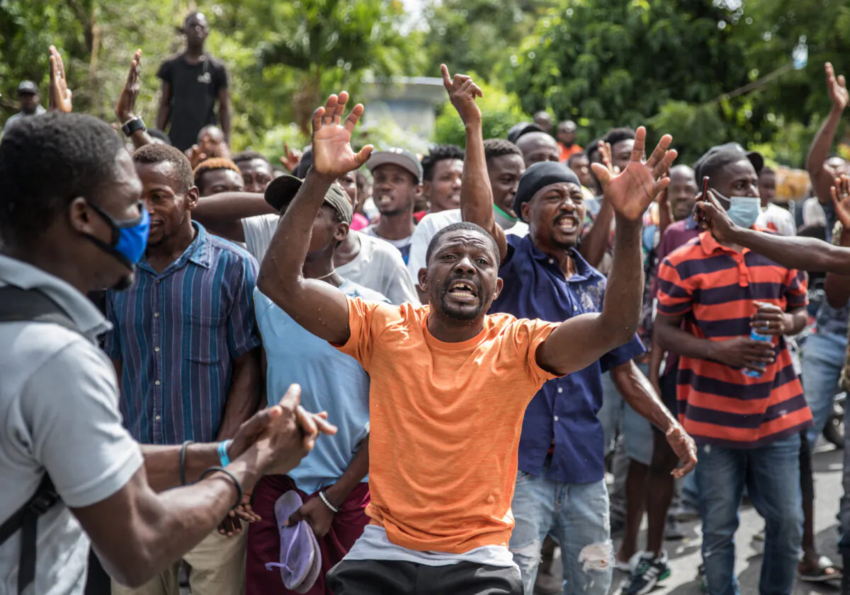 The crowd reacts near the Petionville Police station where armed men, accused of being involved in the assassination of President Jovenel Moise, are being detained in Port au Prince on July 8, 2021. (Valerie Baeriswyl/AFP via Getty Images)