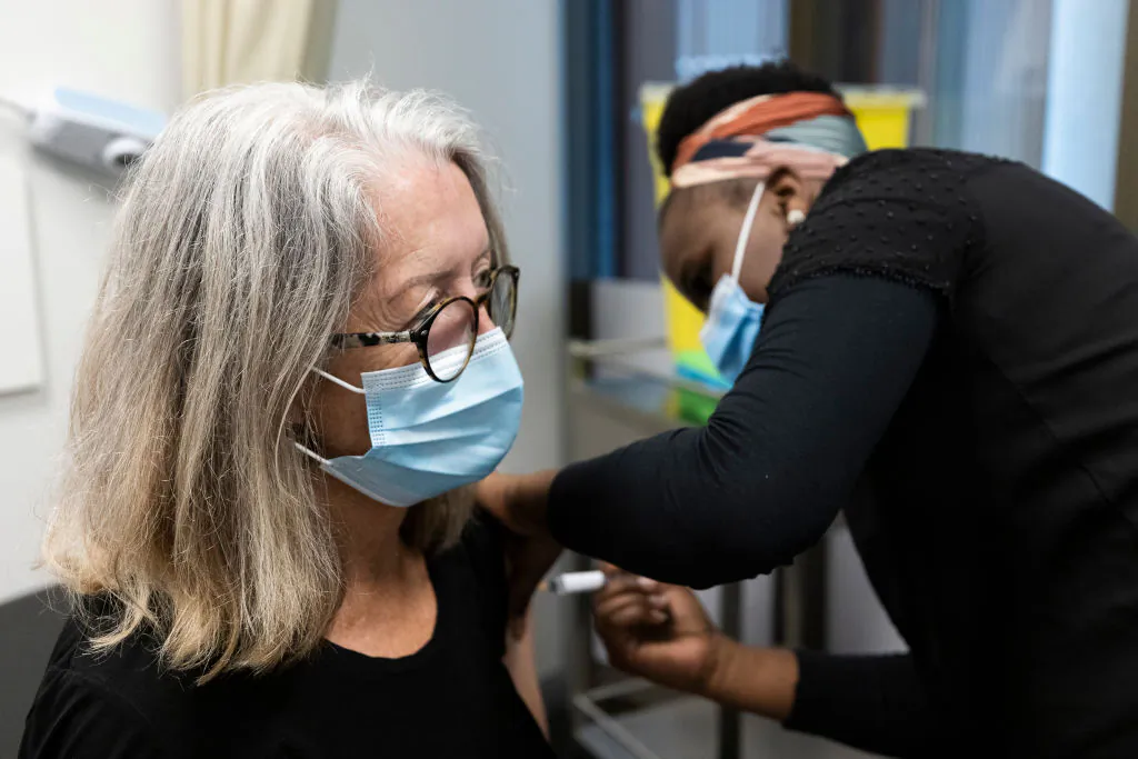 A nurse administers the AstraZeneca vaccine to a woman at the Sydney West COVID Vaccine Centre in Australia, on May 7, 2021 (Brook Mitchell/Getty Images)