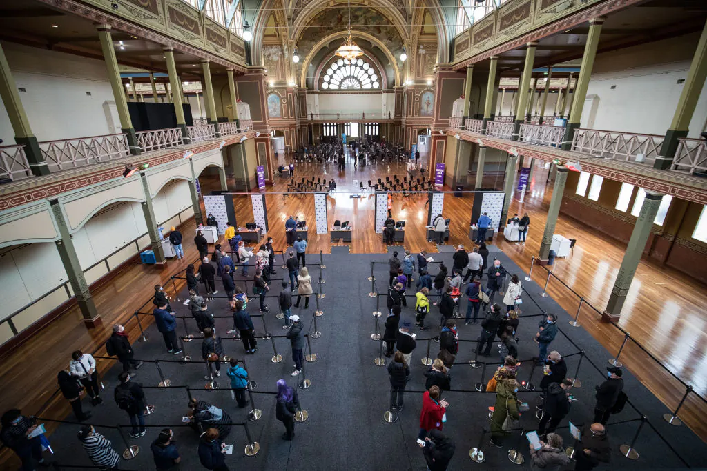 People wait to be register their information before being vaccinated at the Royal Exhibition Building COVID-19 Vaccination Centre in Melbourne, Australia on May 28, 2021. (Darrian Traynor/Getty Images)
