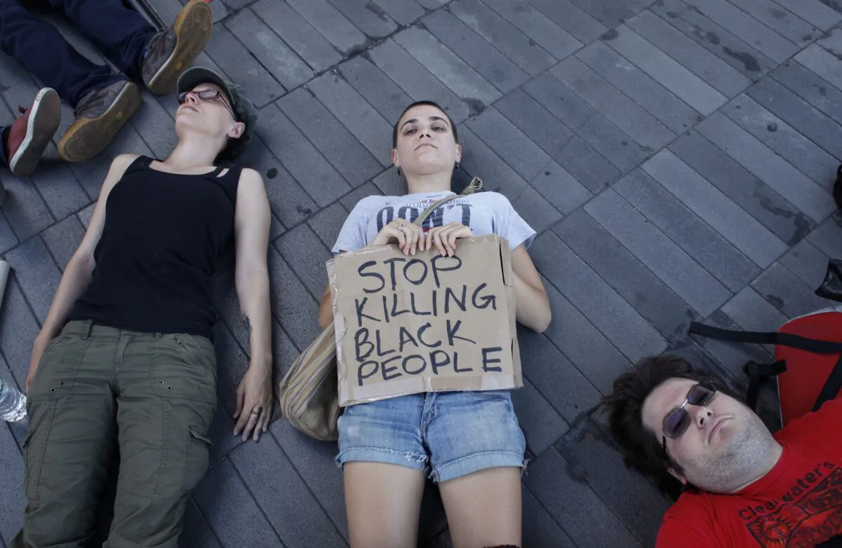 Demonstrators take part in a die-in during a Michael Brown memorial protest in Brooklyn, New York on Aug. 9, 2015. (Kena Betancur/AFP via Getty Images)