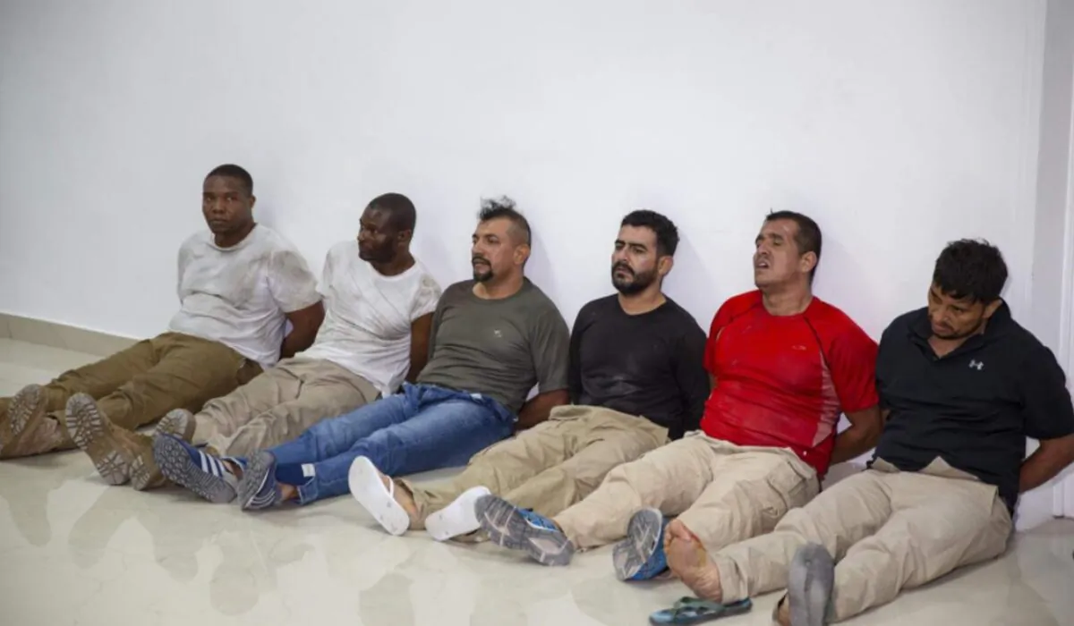 Suspects in the assassination of Haiti's President Jovenel Moïse, among them Haitian American citizens James Solages, left, and Joseph Vincent, second left, are shown to the media at the general direction of the police in Port-au-Prince, Haiti, on July 8, 2021. (Joseph Odelyn/AP Photo)
