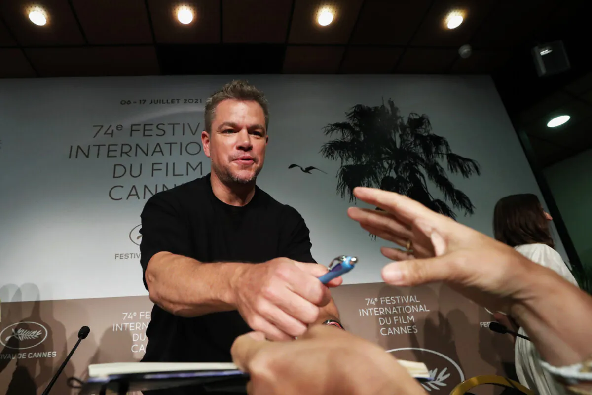 Cast member Matt Damon signs autographs at a press conference for the film "Stillwater" at the 74th Cannes Film Festival in Cannes, France, on July 9, 2021. (Eric Gaillard/Reuters)