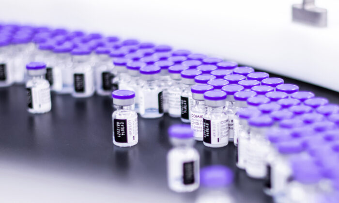 Vials of the Pfizer-BioNTech COVID-19 vaccine are prepared for packaging at the company’s facility in Puurs, Belgium, in March 2021. (Pfizer via AP)